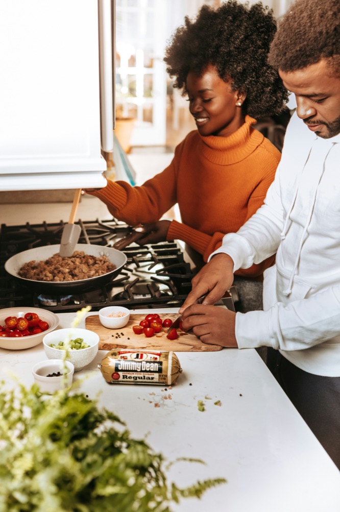 Creators cooking together with a sponsored product on the counter