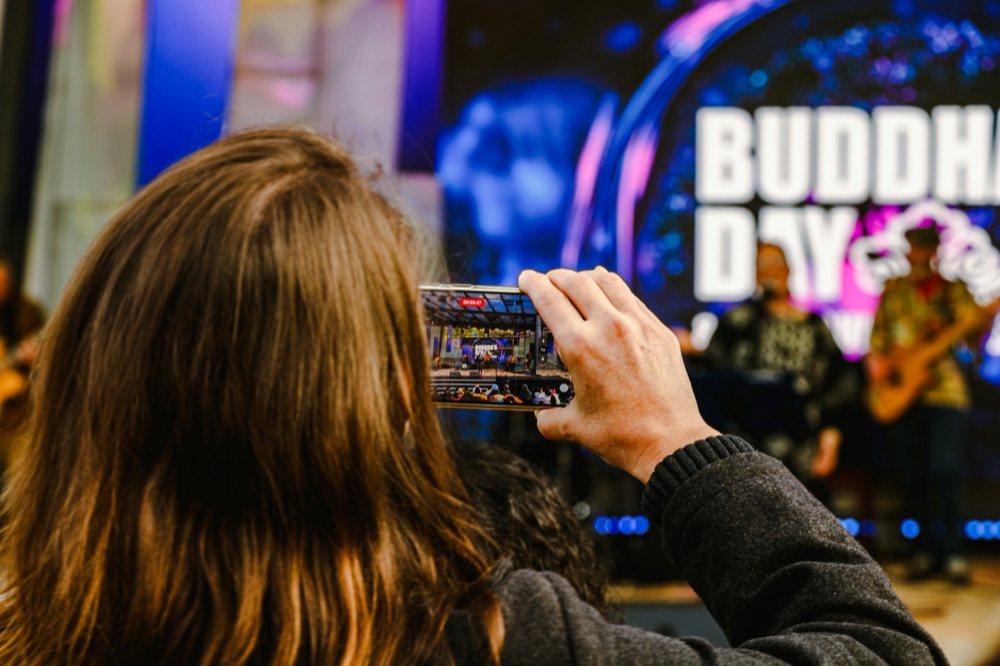 Creator filming a live event on their phone