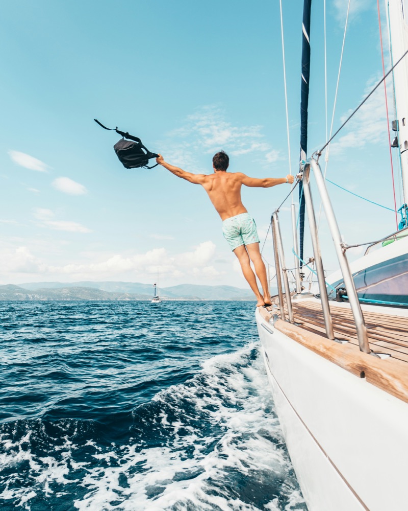 Creator jumping off a sailboat into the ocean