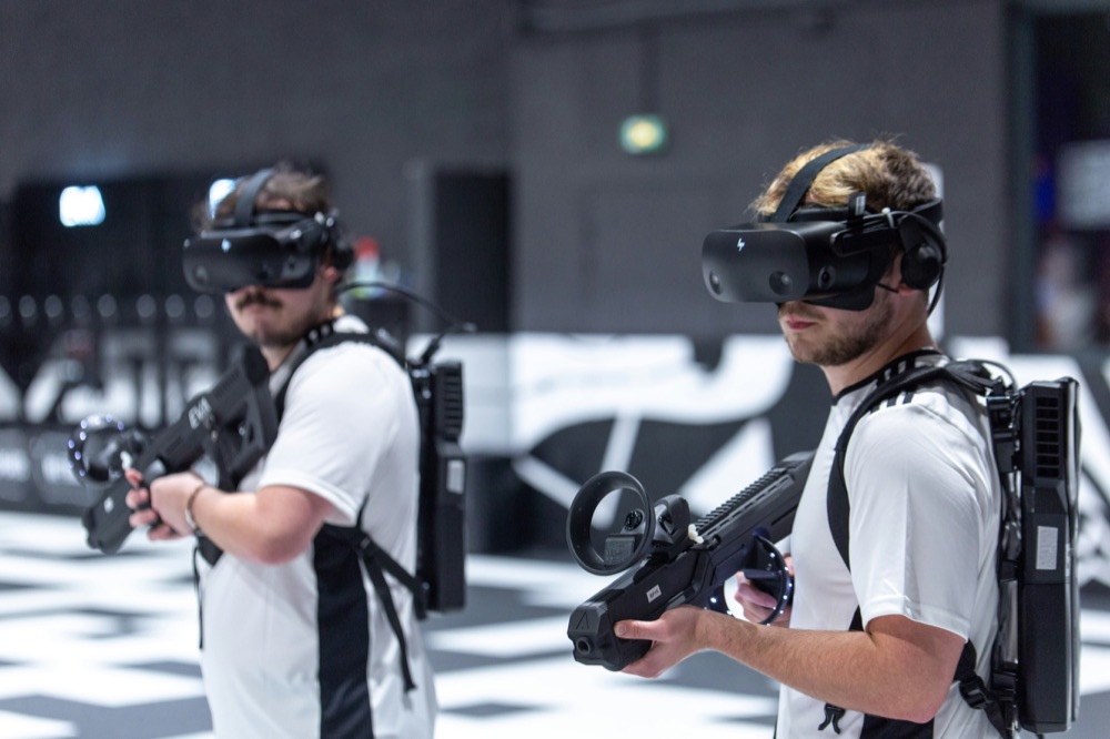 Two creators playing a VR laser tag experience