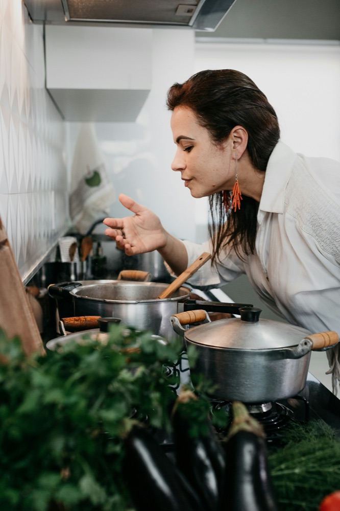 Creator tasting food cooking on the stove