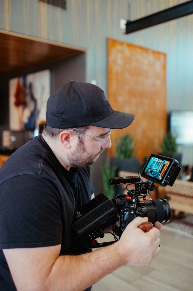 Creator operating a cinema camera on set